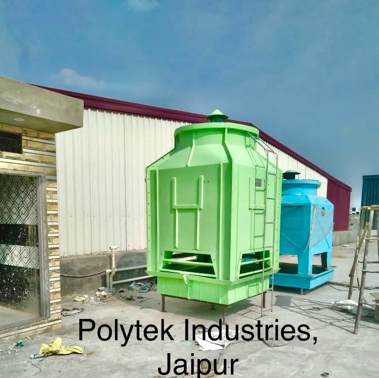 Green square FRP cooling tower and a blue rectangular tower installed side by side at Polytek Industries Jaipur