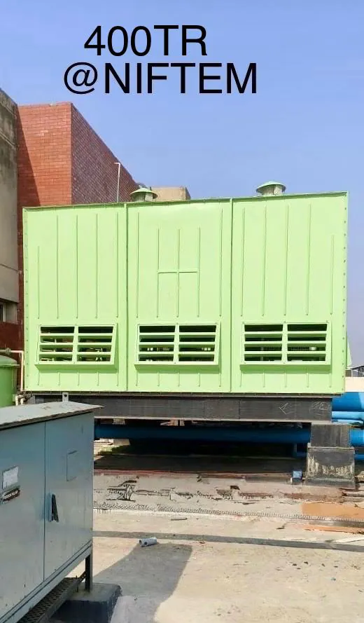 Green three cell FRP cooling tower rated 400 TR with louvred air inlets installed at NIFTEM Kundli