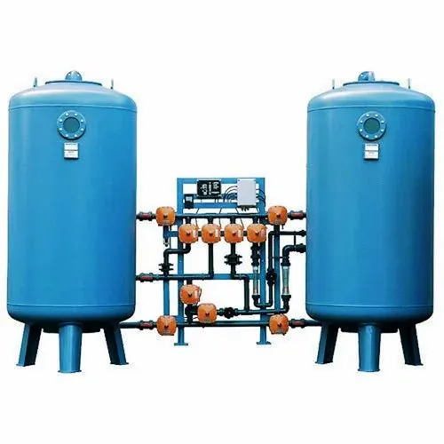 Two blue vertical pressure vessels linked by an orange and blue valve manifold with a control panel